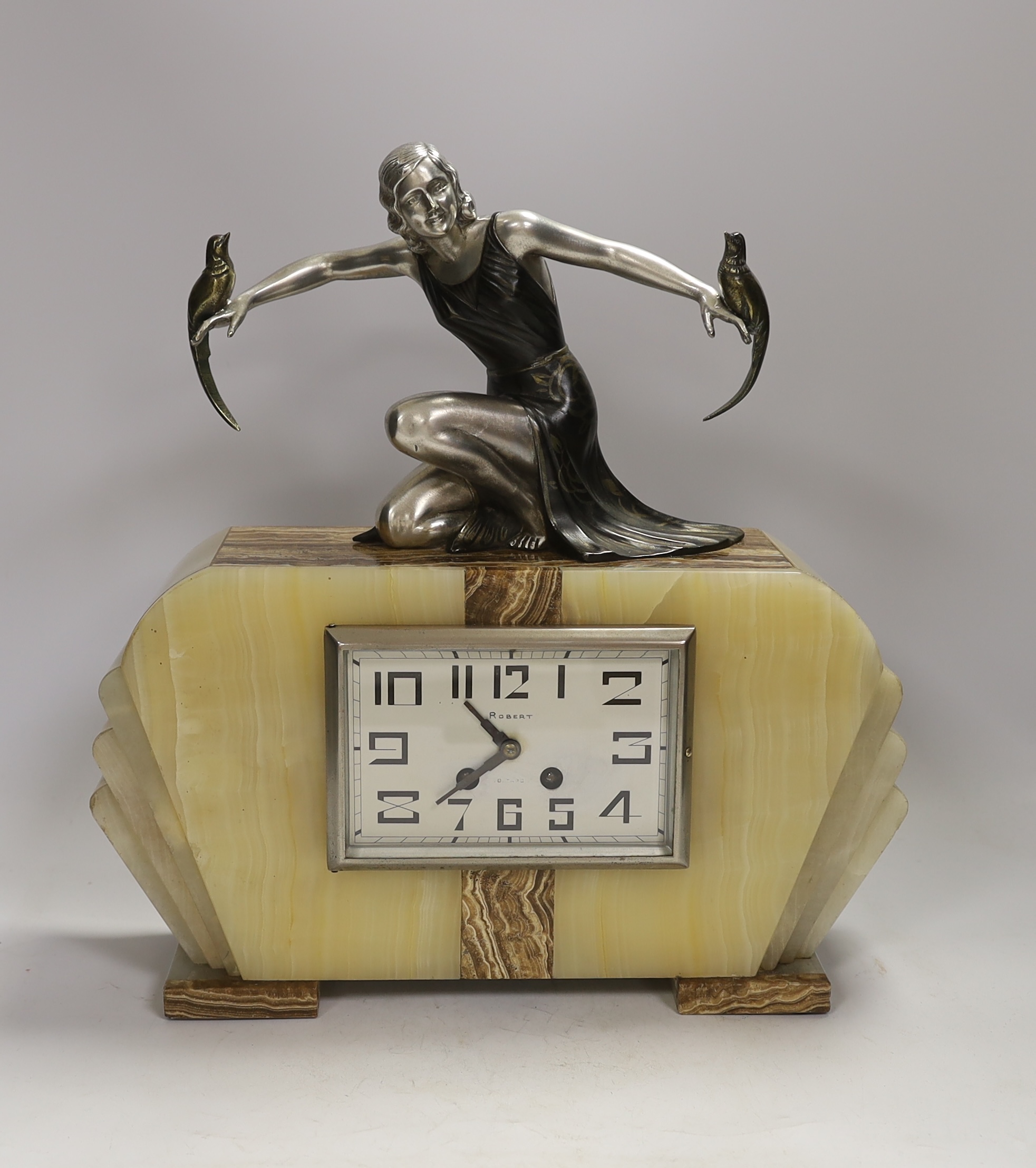 A French Art Deco onyx and spelter mantel clock, signed S. Moralni, with key and pendulum, 39cm